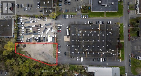 An aerial view of a parking lot with a red rectangle highlighting a specific area.