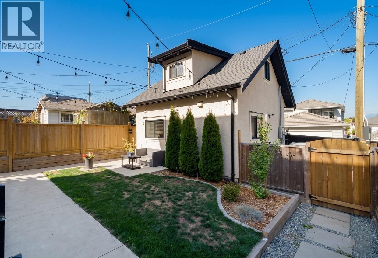 A house with a well-maintained lawn and a wooden fence.