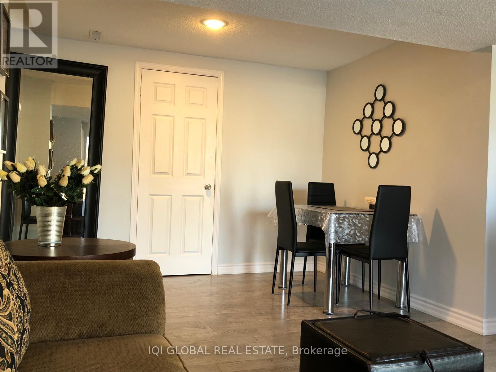 A dining room with a table set for four.