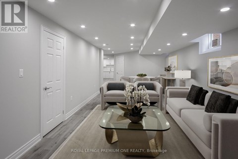 A well-lit, modern living room with a glass coffee table and a white sofa.