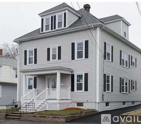 A two story house with a grey and white exterior.