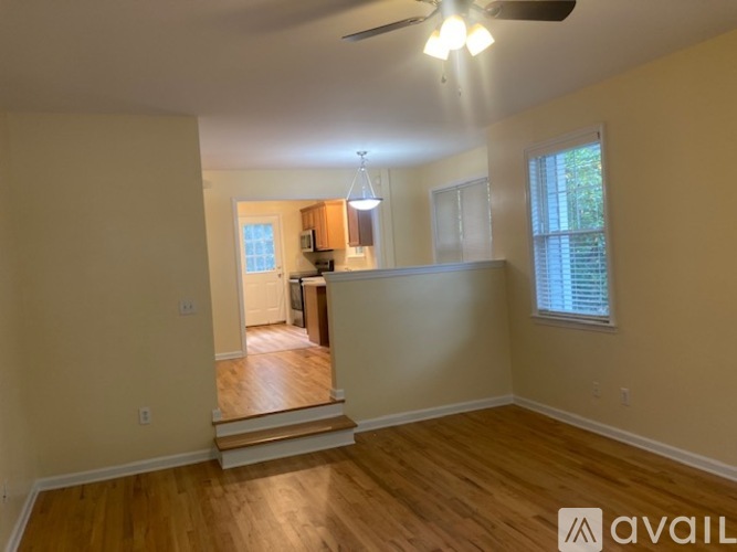 A room with wooden floors and a ceiling fan.