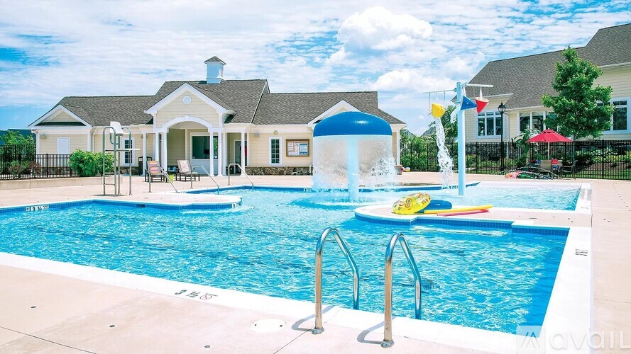 A pool with a blue umbrella and a yellow float.