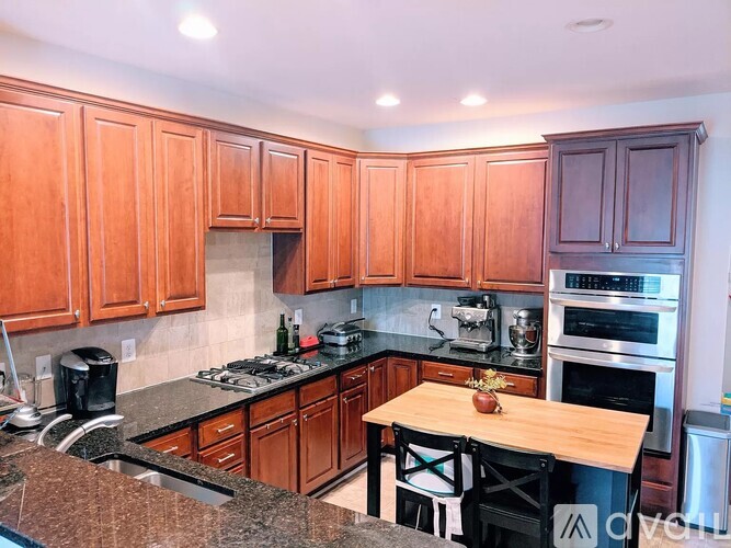 A kitchen with wooden cabinets and a granite countertop.