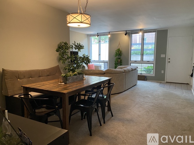 A dining area with a wooden table and chairs.