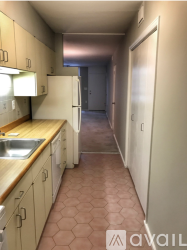 A kitchen with a sink and a refrigerator.