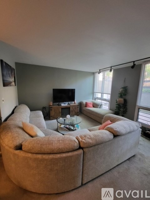 A living room with a large couch and a television.
