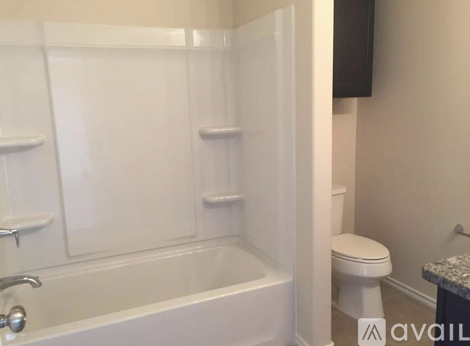 A white bathroom with a toilet and a bathtub.
