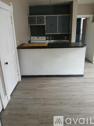 A kitchen with a white counter and cabinets.