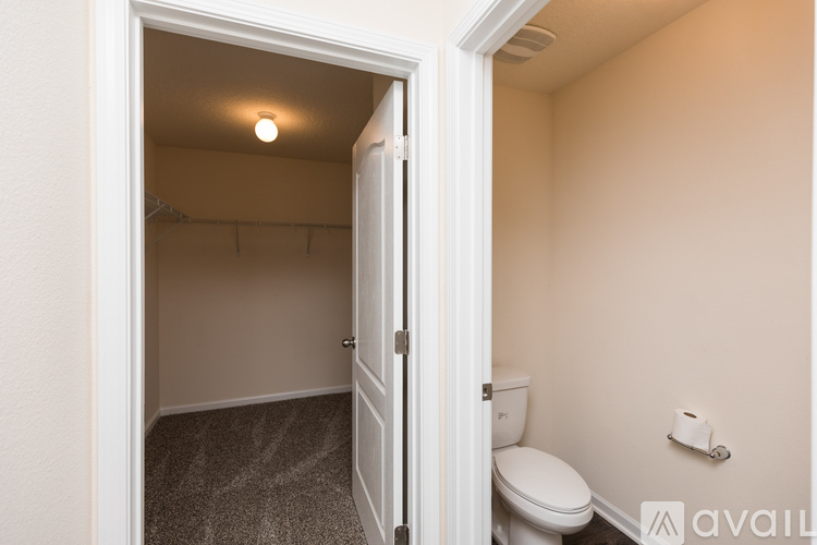 A small bedroom with a toilet and a closet.