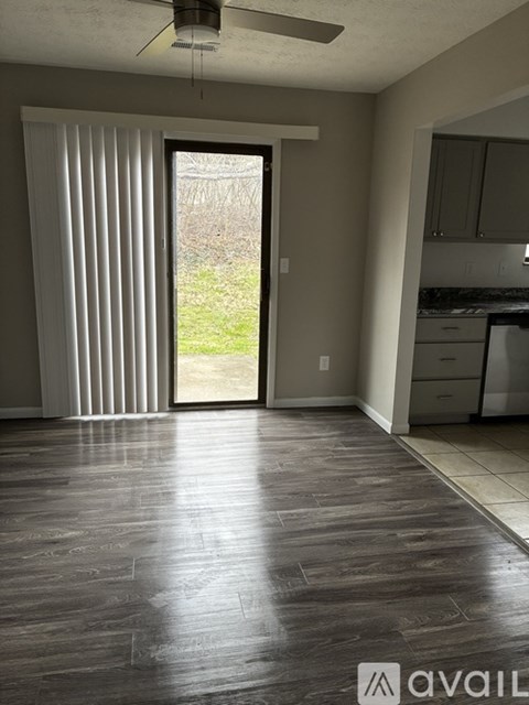 A room with a sliding glass door leading to a backyard.