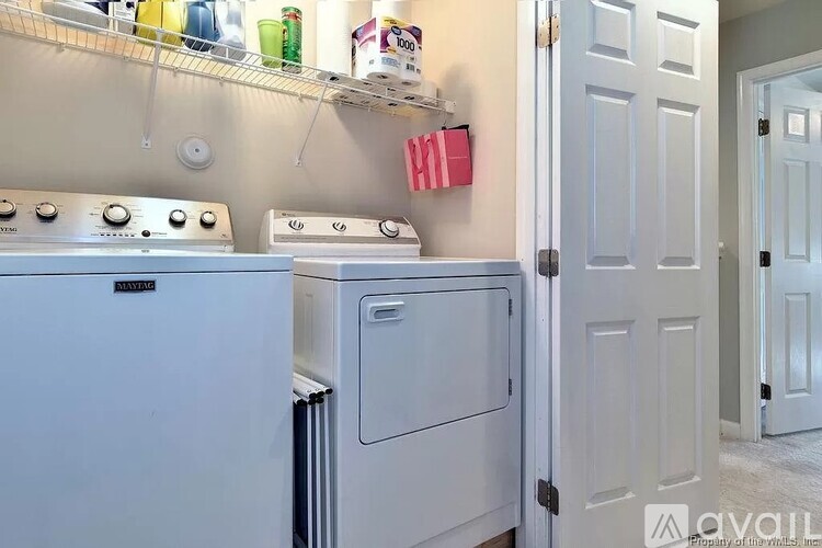 A white oven and dishwasher in a kitchen.