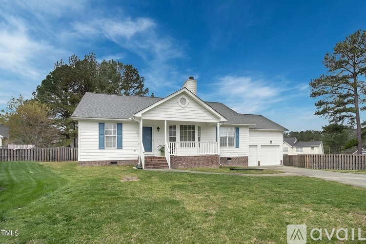 A white house with a blue door and a small porch.