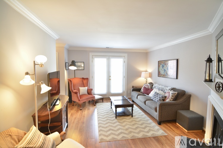 A living room with a couch, chair, and table.