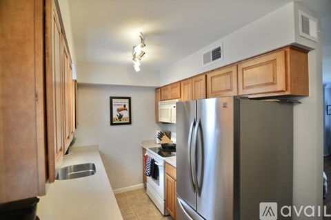 A kitchen with wooden cabinets and stainless steel appliances.