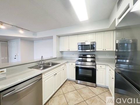 A kitchen with white cabinets and stainless steel appliances.