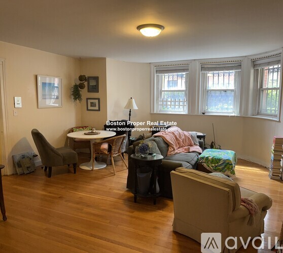 A living room with a couch, chair, and table.