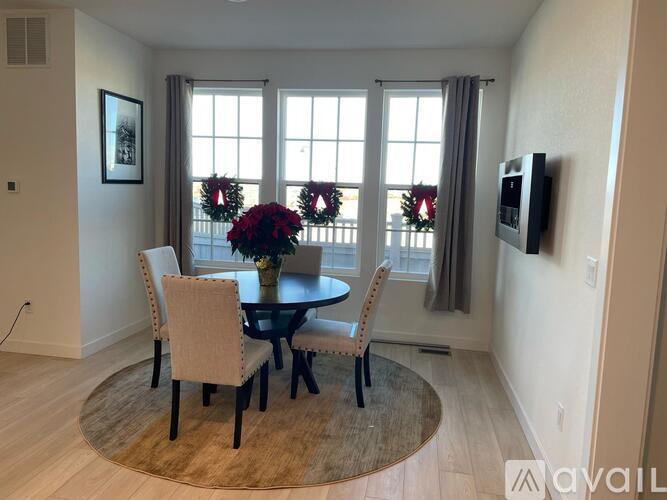 A dining room with a round table and chairs.