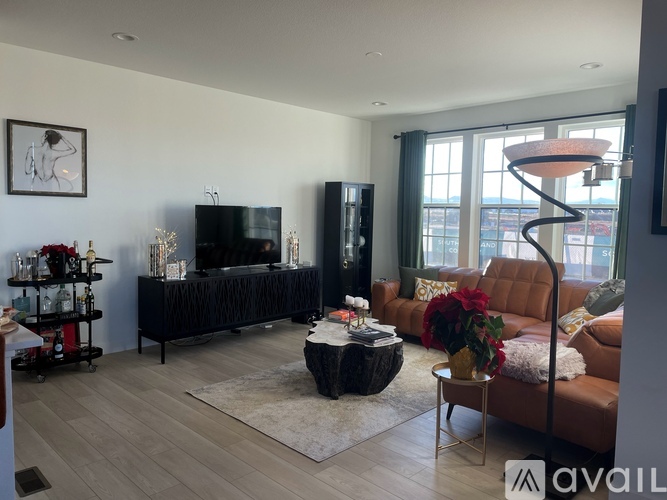 A living room with a black sofa and a television.