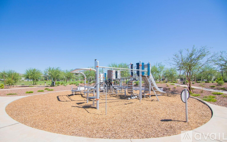 A playground with a slide and swings in the foreground.