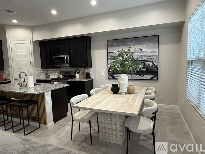 A modern kitchen with a dining table set for six.
