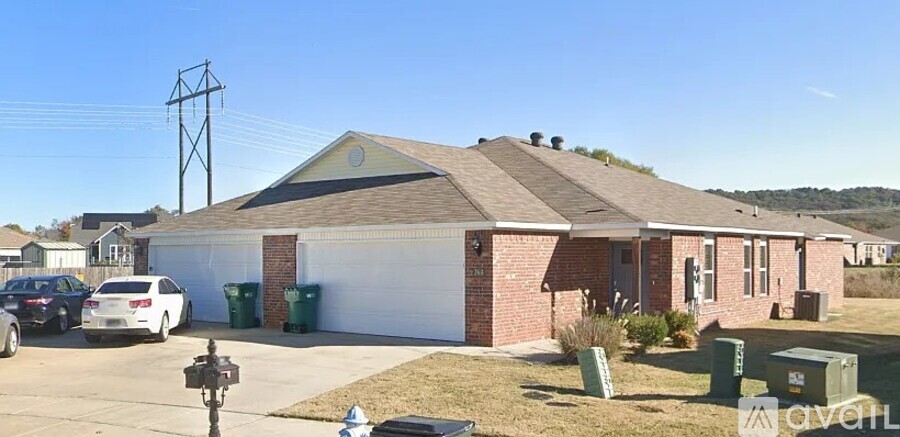 A house with a garage and a car parked in front.