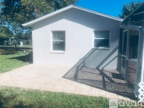 A white house with a patio and a door.