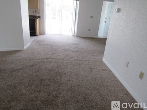 A house with a white wall and a black door is for sale.