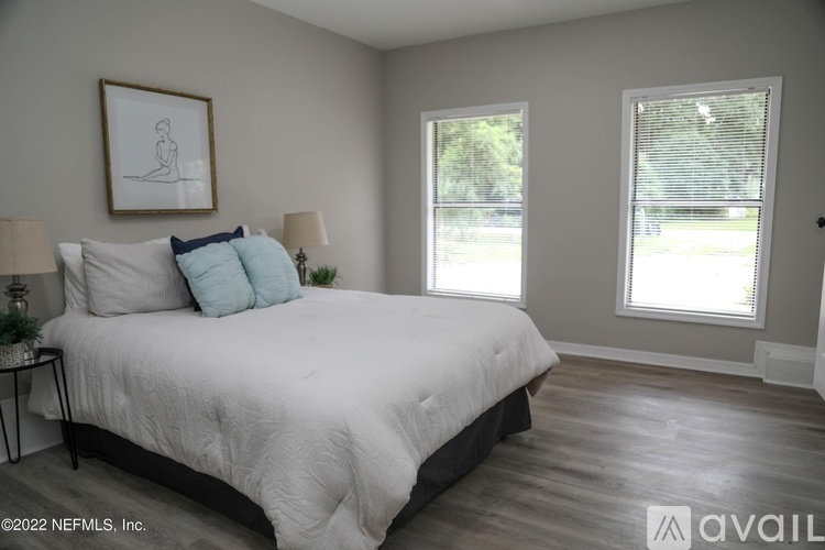 A bedroom with a large bed and a window.