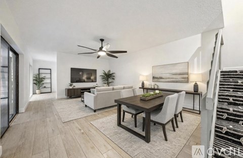 A modern living room with a dining table and chairs.