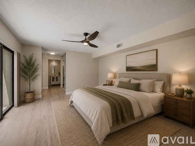 A bedroom with a bed, nightstand, and a ceiling fan.