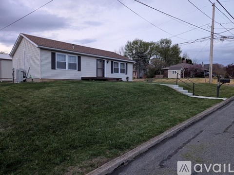 A house with a lawn in front of it.