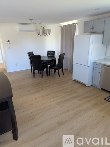 A kitchen with a table and chairs in the middle of the room.