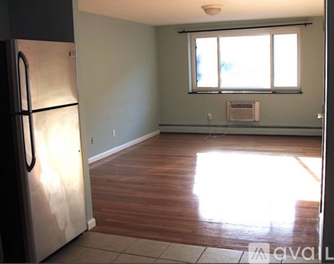 A kitchen with a refrigerator and a window.