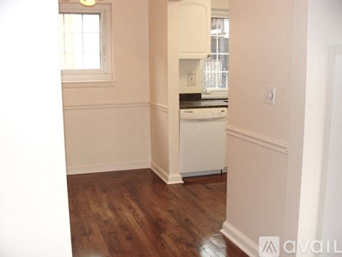 A kitchen area with a white cabinet and a window.