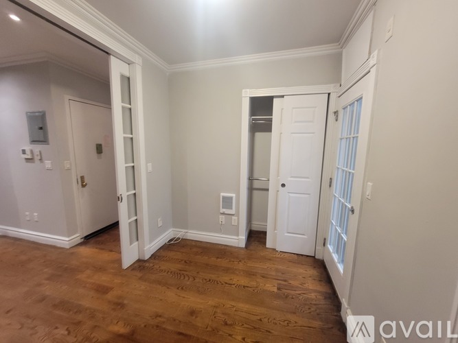 A room with a wooden floor and white walls.