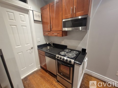 A kitchen with wooden cabinets and a black stove top.