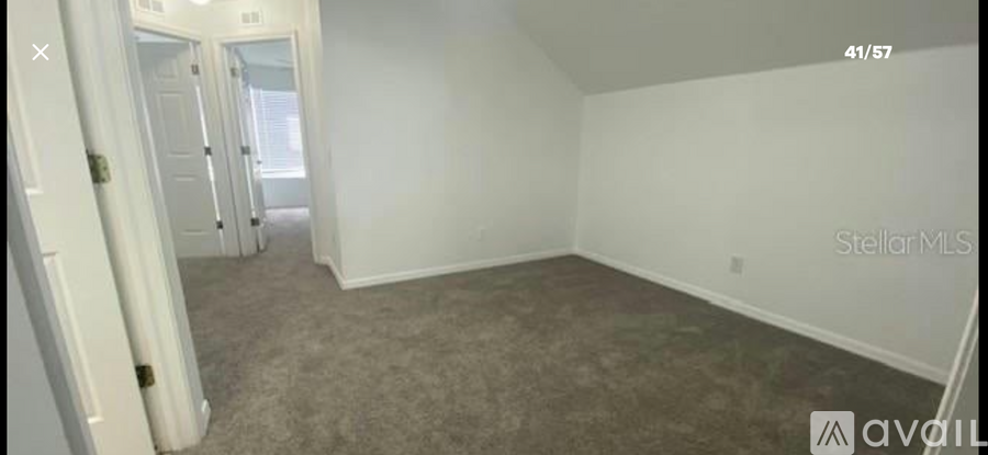 A room with carpeted floor and white walls.