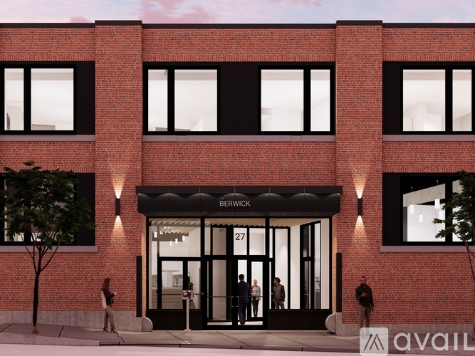 A red brick building with the number 27 on the door.
