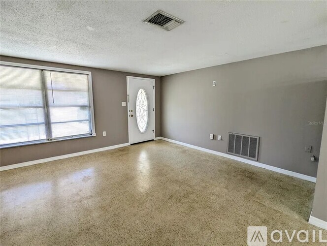 A spacious room with a door and a window.