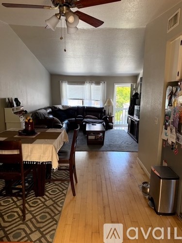 A living room with a dining table and chairs.
