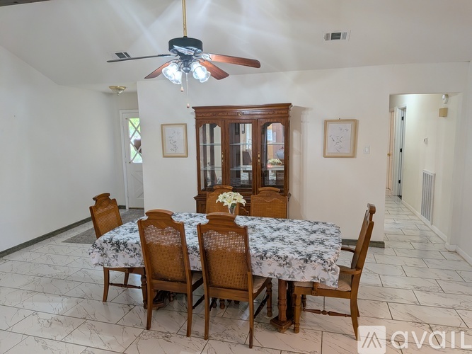 A dining room with a table set for six.
