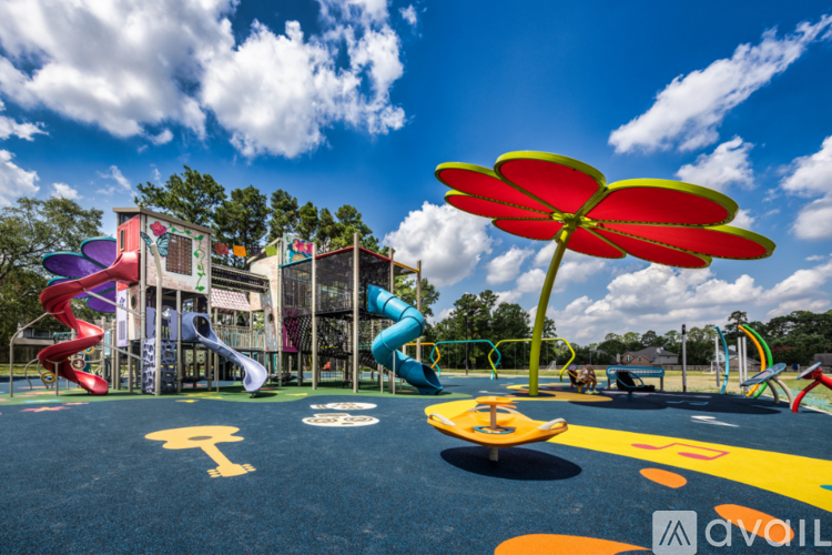 A playground with a slide, swings, and a climbing wall.