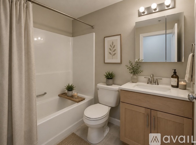A bathroom with a toilet, sink, and bathtub.
