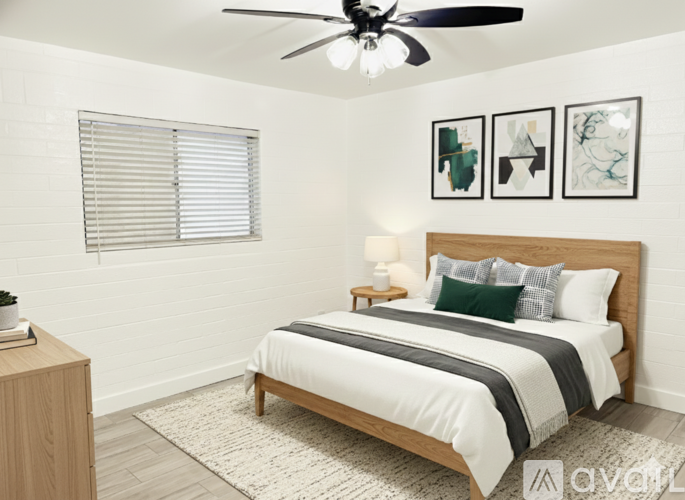 A bedroom with a bed, nightstand, and a ceiling fan.