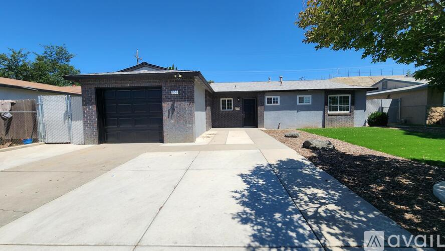 A two-story house with a garage is for sale.