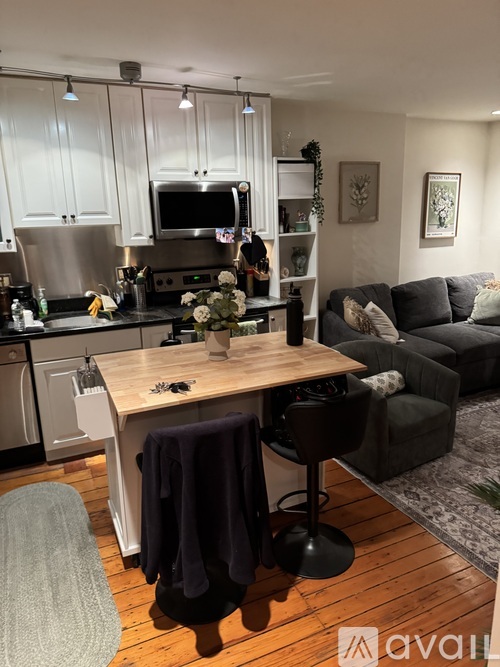 A kitchen with a table and chairs in the middle of the room.