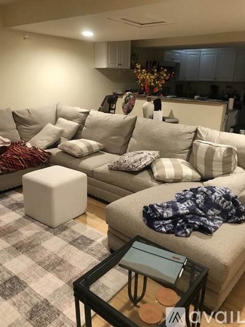 A living room with a grey couch and a coffee table.