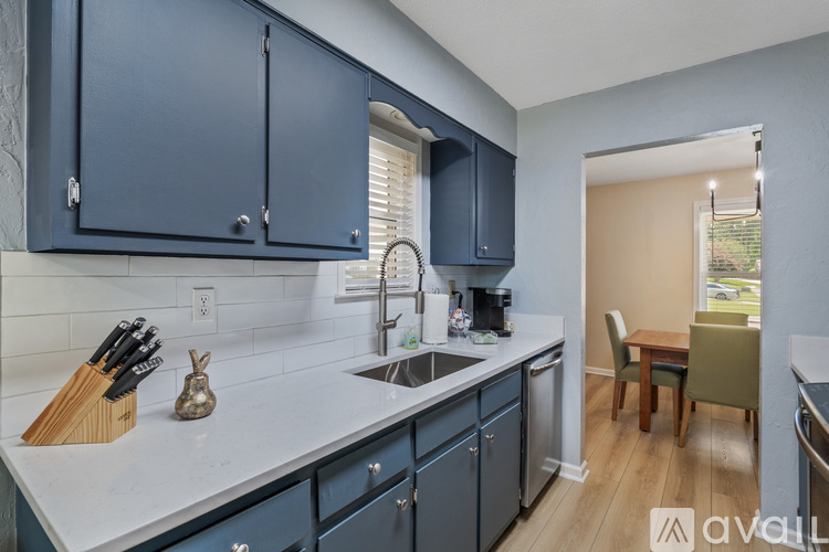 A kitchen with dark blue cabinets and a white countertop.