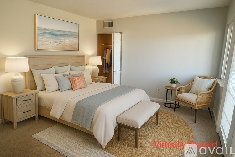 A bedroom with a large bed and a painting on the wall.